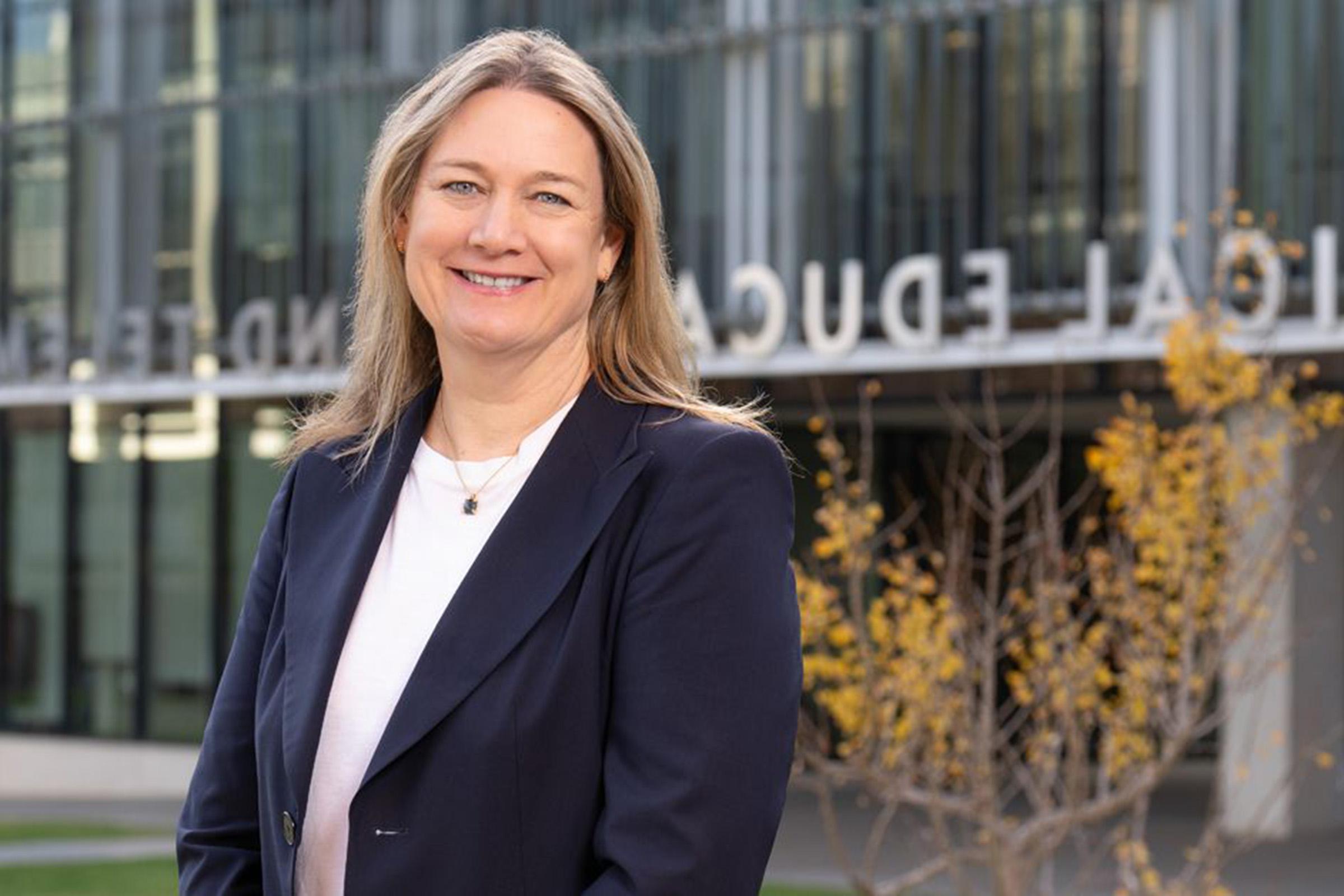 Dr. Barbara Jung is pictured in front of a School of Medicine building